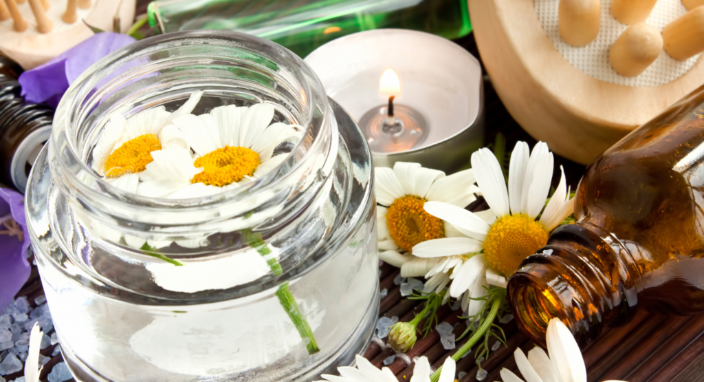 daisy and flower essence with candle