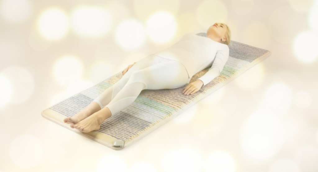 healthyline infrared crystal mat with women lying on it